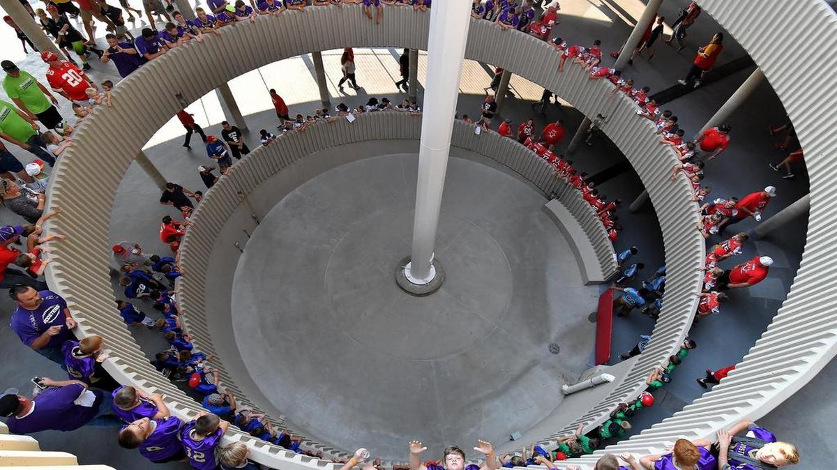 Youth football players and their parents lined up around one of the spiral ramps before getting a chance to walk on the field before Thursday’s preseason football game between the Kansas City Chiefs and Tennessee Titans at Arrowhead Stadium. Outside, some fans were having difficulties accessing electronic parking passes before the game