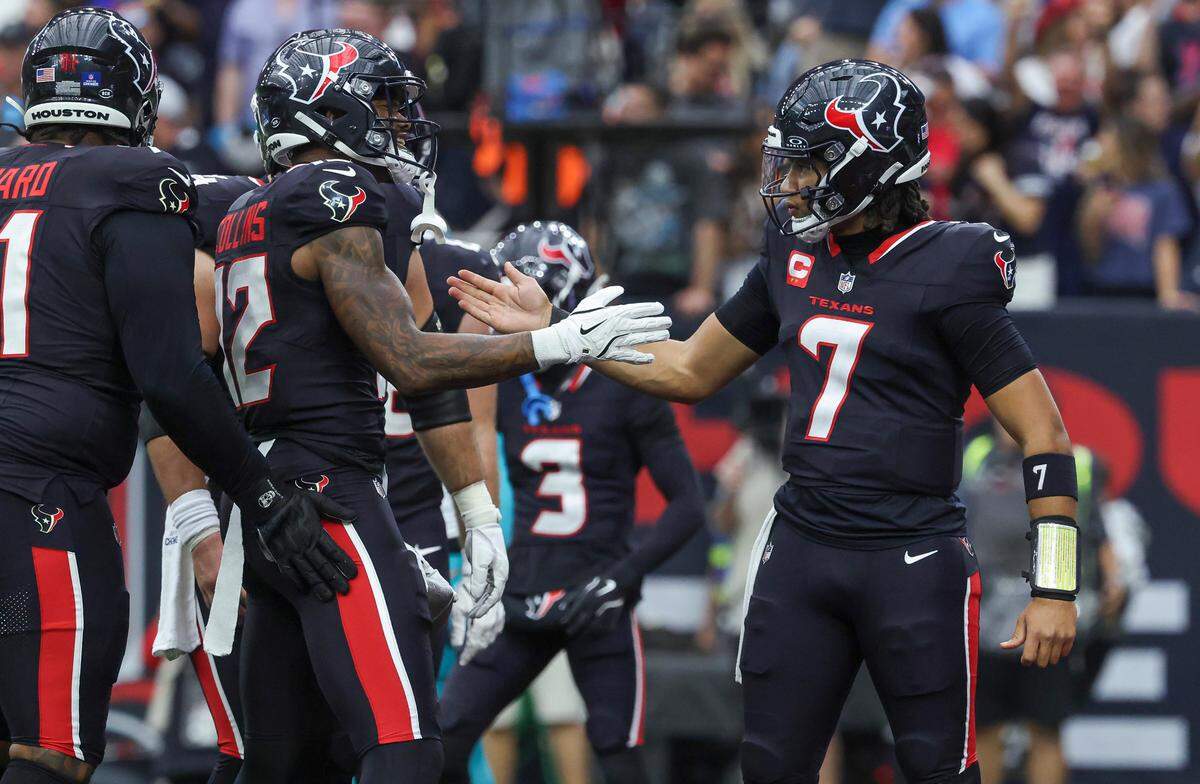 Houston Texans wide receiver Nico Collins (12) celebrates with quarterback C.J. Stroud (7) after a touchdown reception during the second quarter against the Miami Dolphins on Dec. 15, 2024 at NRG Stadium in Houston.