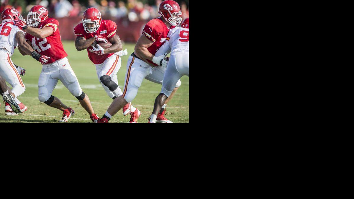 
Chiefs running back Knile Davis (center) ran through a opening in the offensive line at summer training camp practice at Missouri Western State University in St. Joseph.
