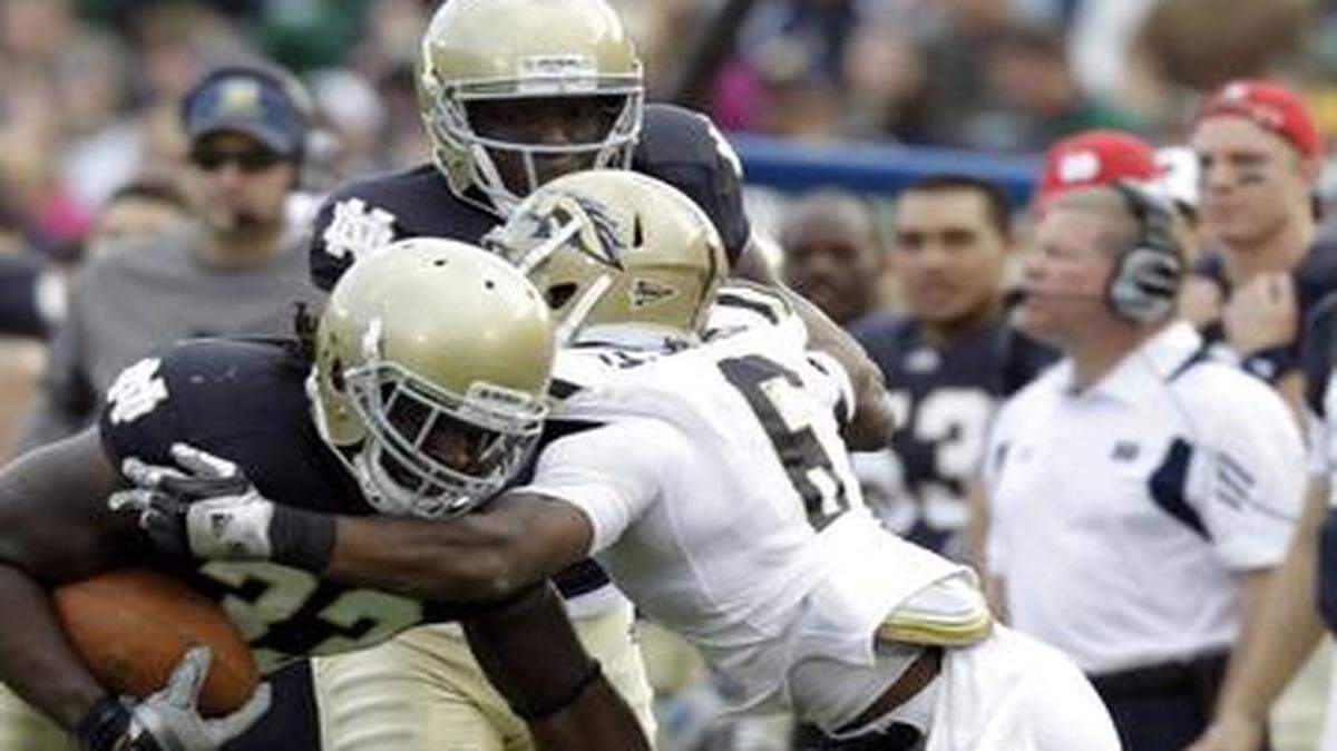 
New KC Chiefs cornerback Damond Smith (right) began his career at Western Michigan, where he tackled Notre Dame running back Robert Hughes in a game on Oct. 16, 2010.


