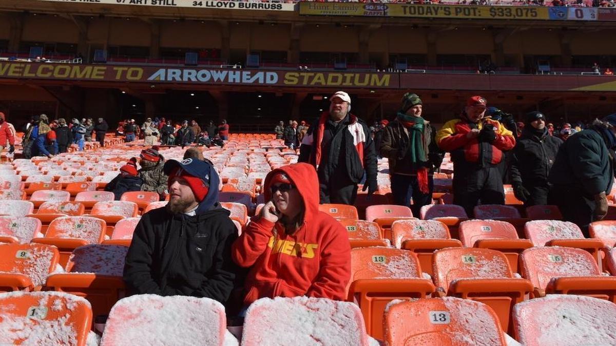 Kansas City Chiefs and Tennessee Titans fan Alix and Nicholas Sears from Missouri Valley, Iowa, bask in the dun brfore Sunday's football game at Arrowhead Stadium in Kansas City, Mo.