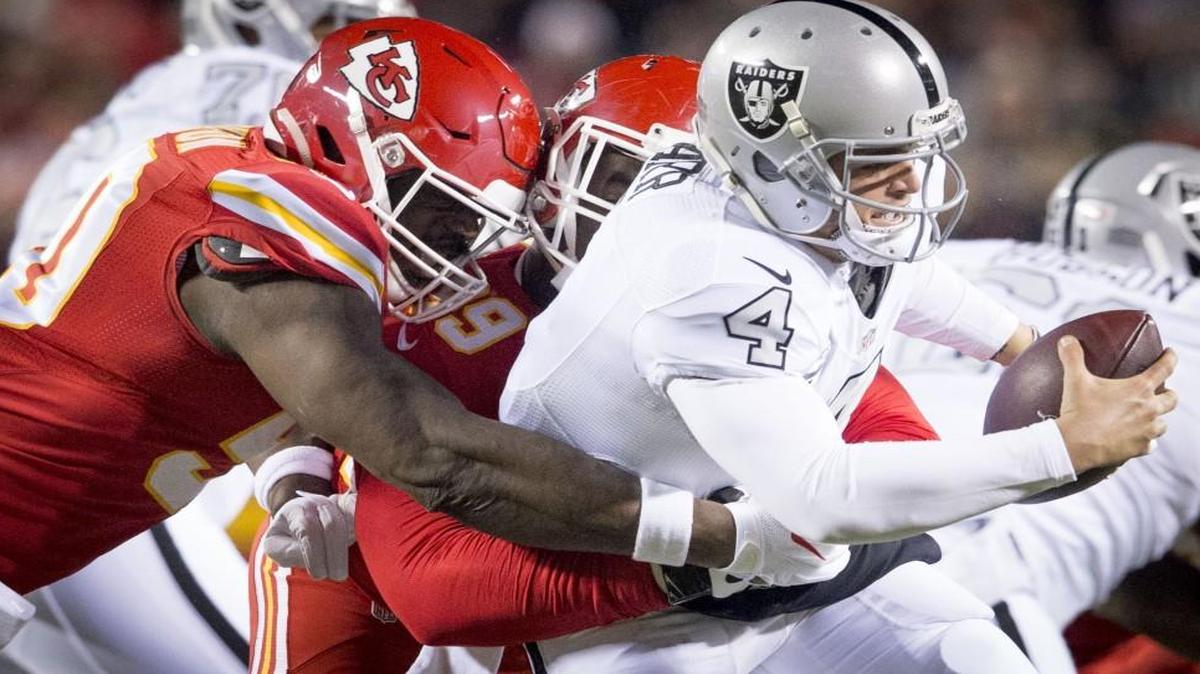 Kansas City Chiefs outside linebacker Justin Houston (left) and Kendall Reyes sacked Oakland Raiders quarterback Derek Carr (4) during a game on Dec. 8.