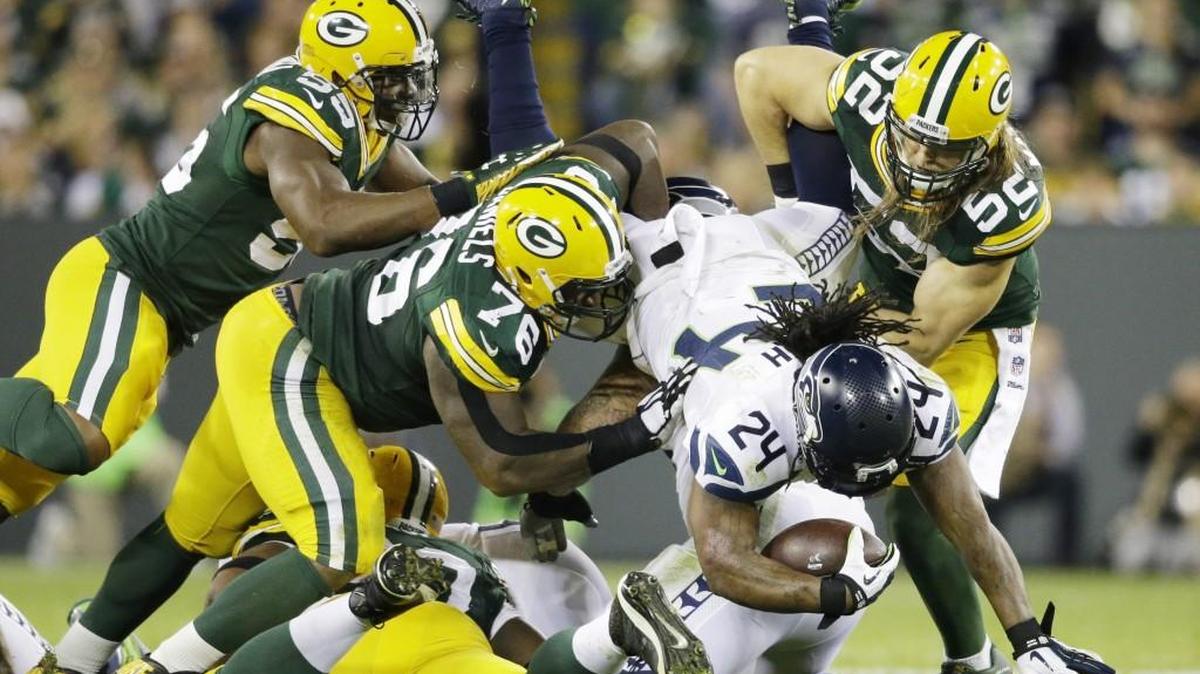 Andy Mulumba (right) spent the last three years with the Green Bay Packers, recording 35 tackles and one sack in 22 games.
