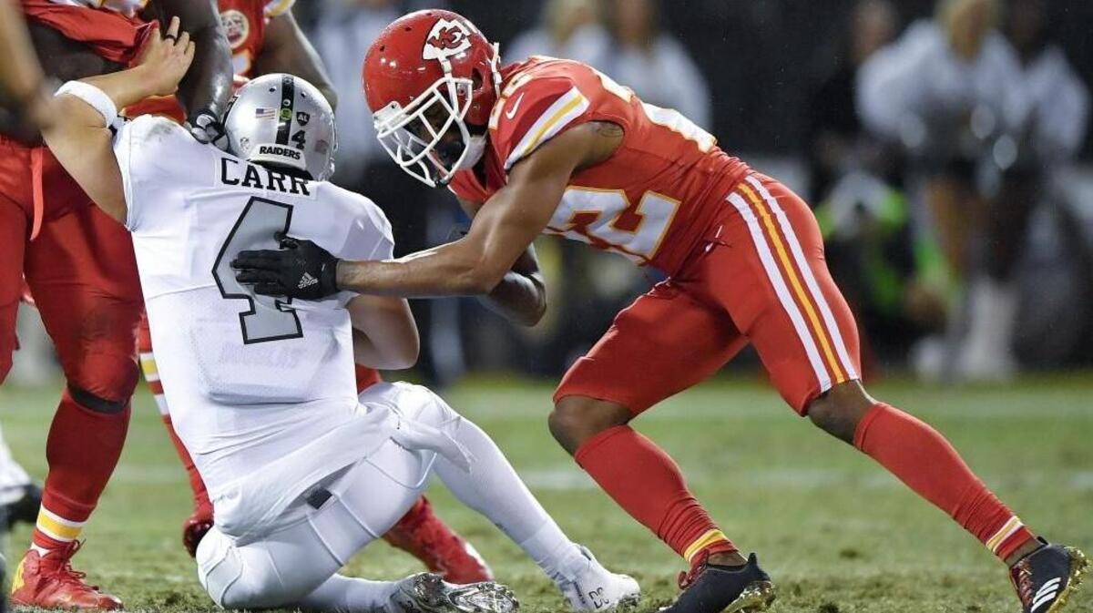 Cornerback Marcus Peters, right, was penalized during the Chiefs’ Oct. 19 loss at Oakland for this late hit on David Carr in the second quarter. This week, Peters was also fined by the NFL for the infraction.