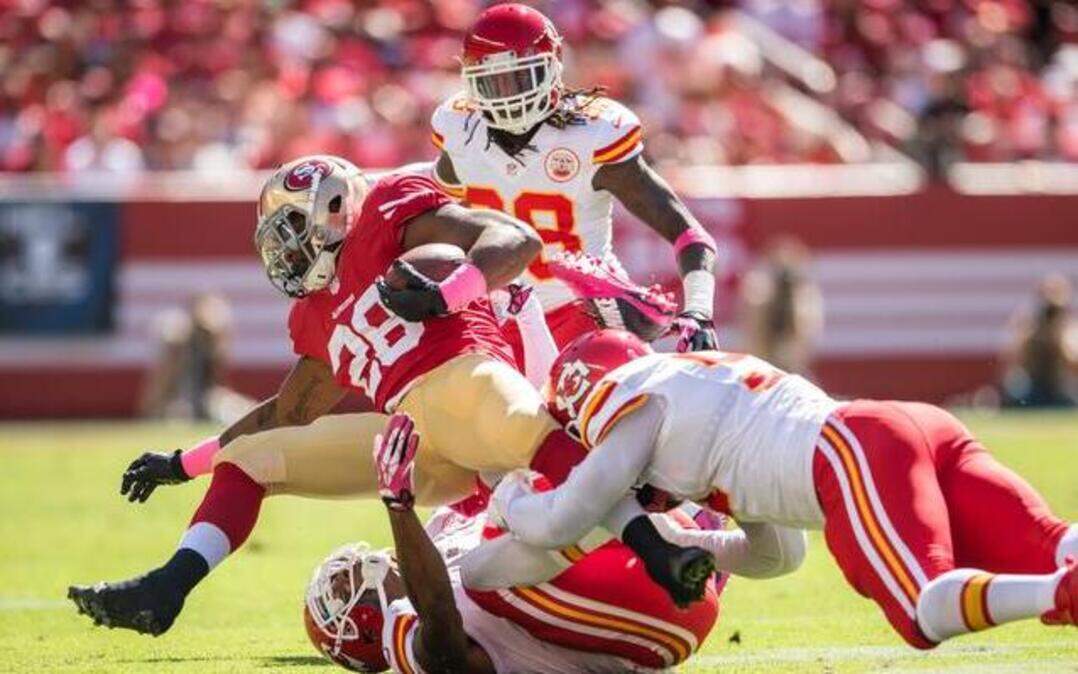 
San Francisco 49ers running back Carlos Hyde (left) ran over Chiefs cornerback Sean Smith (21) in the first quarter Sunday at Levi’s Stadium in Santa Clara, Calif. Especially in the second half, the Chiefs couldn’t seem to take control of the 49ers’ ground game.
