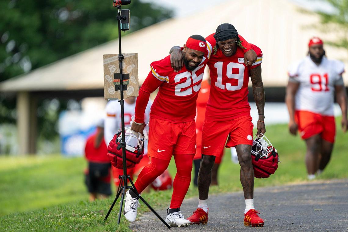 Chiefs running back Clyde Edwards-Helaire (25) and wide receiver Kadarius Toney (19) ham it up for video as they walk to the field for training camp at Missouri Western State University on Tuesday, July 23, 2024, in St. Joseph.