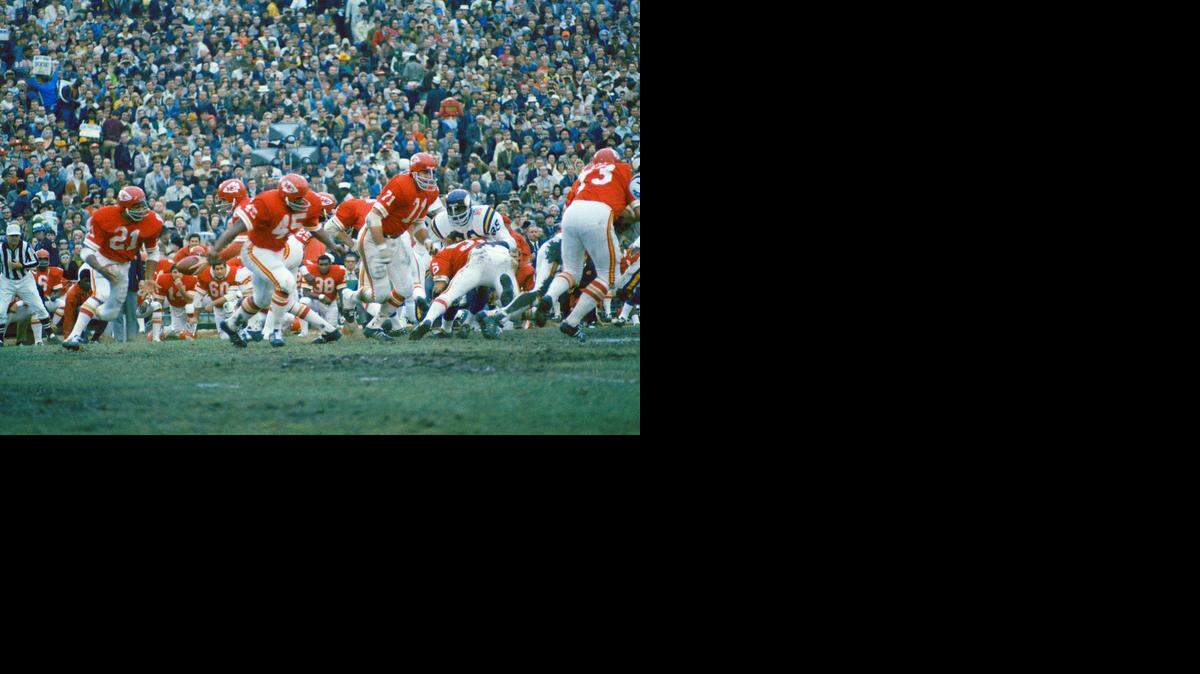 FILE: Kansas City Chiefs quarterback Len Dawson prepares to handoff to running back Mike Garrett (21) as running back Robert Holmes (45) and guard Ed Budde (71) lead the play during the Super Bowl in New Orleans on Jan. 11, 1970.