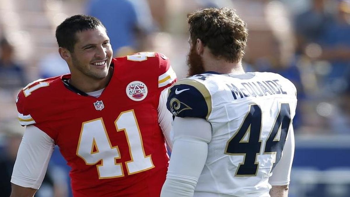 Kansas City Chiefs long snapper James Winchester (left) talks with Los Angeles Rams long snapper Jake McQuaide prior to a preseason NFL football game Saturday.