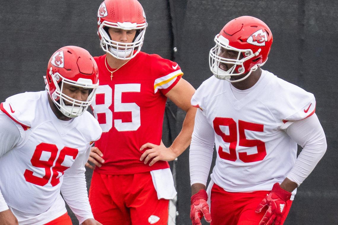 Kansas City Chiefs defensive tackle Chris Jones talking with fellow defensive lineman Fabian Lovett Sr. during warmups on the first day of Chiefs minicamp at the Chiefs practice facility on Tuesday, June 17, 2025.