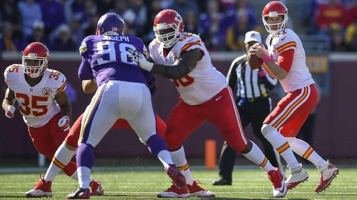 Kansas City Chiefs quarterback Alex Smith (11) looks for an open receiver behind a block from Kansas City Chiefs guard Ben Grubbs (66) against the Minnesota Vikings on October 18, 2015 at TCF Stadium in Minneapolis, MN.