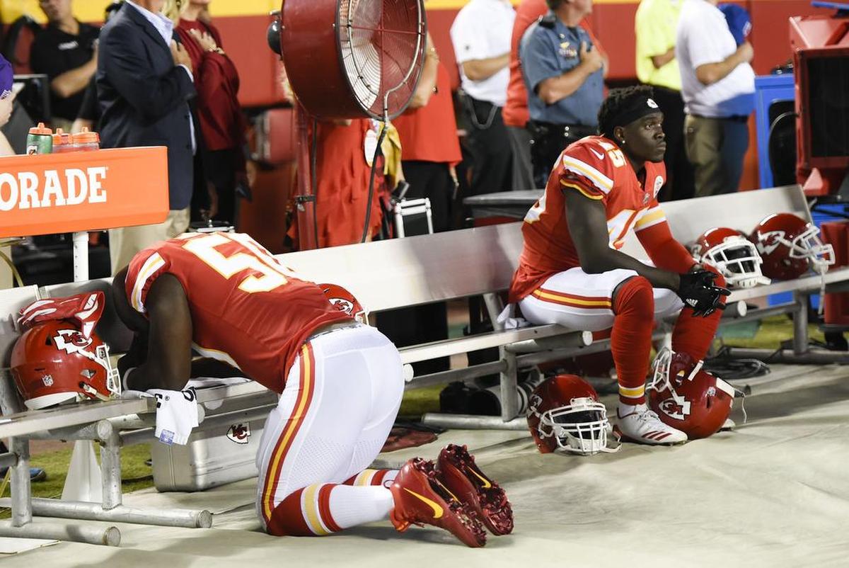 Chiefs linebacker Ukeme Eligwe, right, sat on the bench while teammate Justin Houston prayed during the playing of the national anthem on Oct. 2 at Arrowhead Stadium.