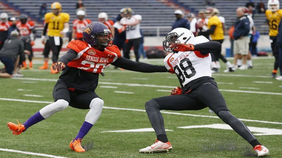 Northern Iowa defensive back Deiondre’ Hall (left) and UMass wide receiver Tajae Sharpe ran through drills during NCAA college football practice for the Senior Bowl on Thursday in Mobile, Ala.