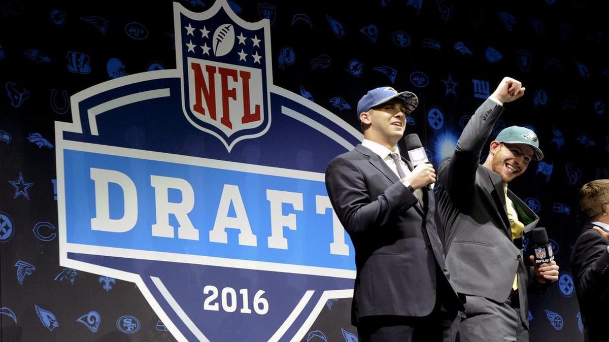 Jared Goff, left, who was selected with the top pick by the Los Angeles Rams, and Carson Wentz, taken by the Philadelphia Eagles with the second pick, greet fans at the NFL football draft Thursday, April 28, 2016, in Chicago.