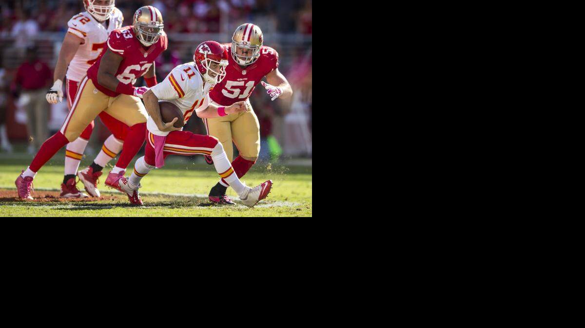 
Chiefs quarterback Alex Smith (11) scrambled away from San Francisco 49ers defensive end Tony Jerod-Eddie (63) and Dan Skuta (51) in the third quarter Sunday at Levi’s Stadium in Santa Clara, Calif. Playing against his old team, Smith and the Chiefs lost 22-17.
