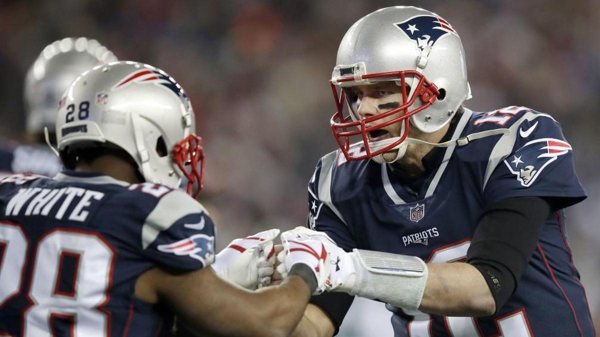 New England Patriots quarterback Tom Brady(right) celebrated a touchdown by running back James White during the AFC Championship Game.