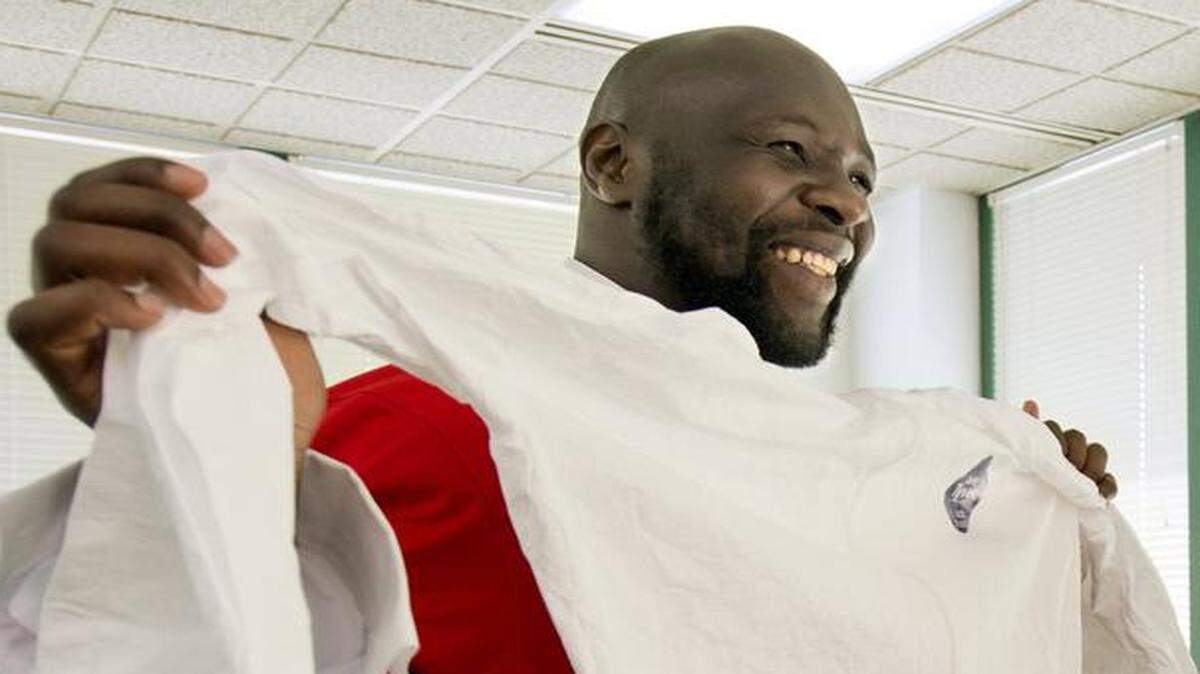 
Chiefs linebacker Tamba Hali, a native of Liberia, visited Heart to Heart International on Tuesday, Oct. 7, 2014, as the nonprofit health organization announced plans to open an Ebola Treatment Unit in Liberia. Hali held up one of the protective suits that will be worn at the 70-bed facility.
