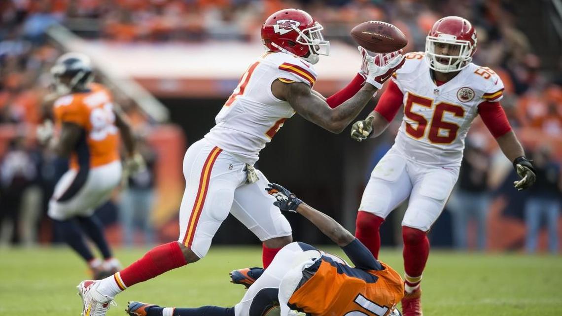Chiefs cornerback Sean Smith (left) intercepted a first-quarter pass intended for Broncos wide receiver Emmanuel Sanders on Sunday in Denver. At right was linebacker Derrick Johnson of the Chiefs.