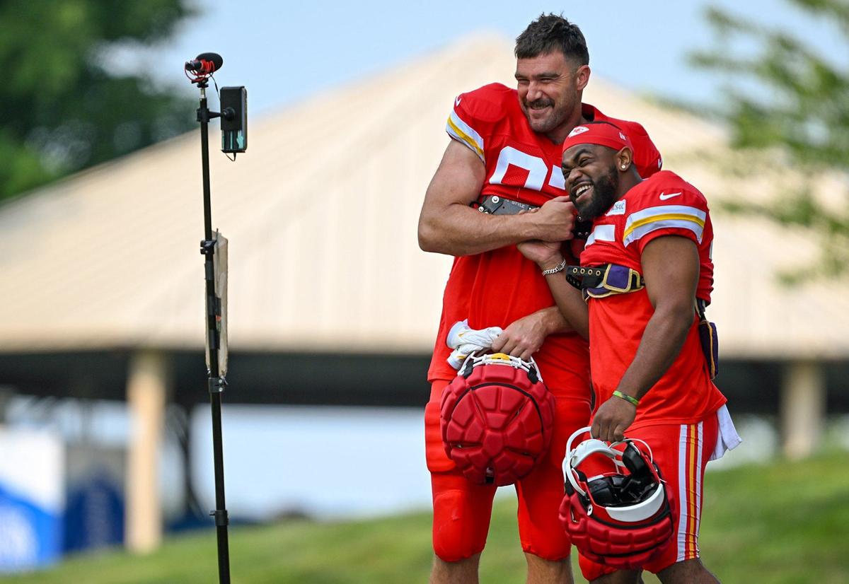 Chiefs tight end Travis Kelce (87) and running back Clyde Edwards-Helaire (25) clown around on the walk to the field for training camp at Missouri Western State University on Saturday, July 27, 2024, in St. Joseph.