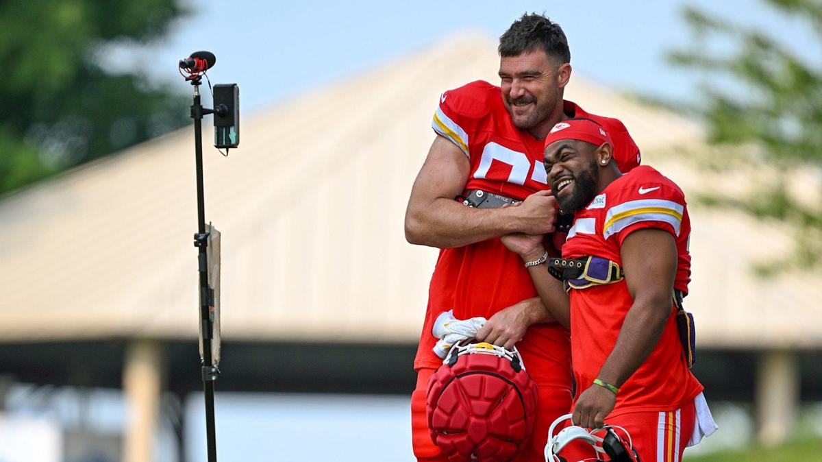 Chiefs tight end Travis Kelce (87) and running back Clyde Edwards-Helaire (25) clown around on the walk to the field for training camp at Missouri Western State University on Saturday, July 27, 2024, in St. Joseph.