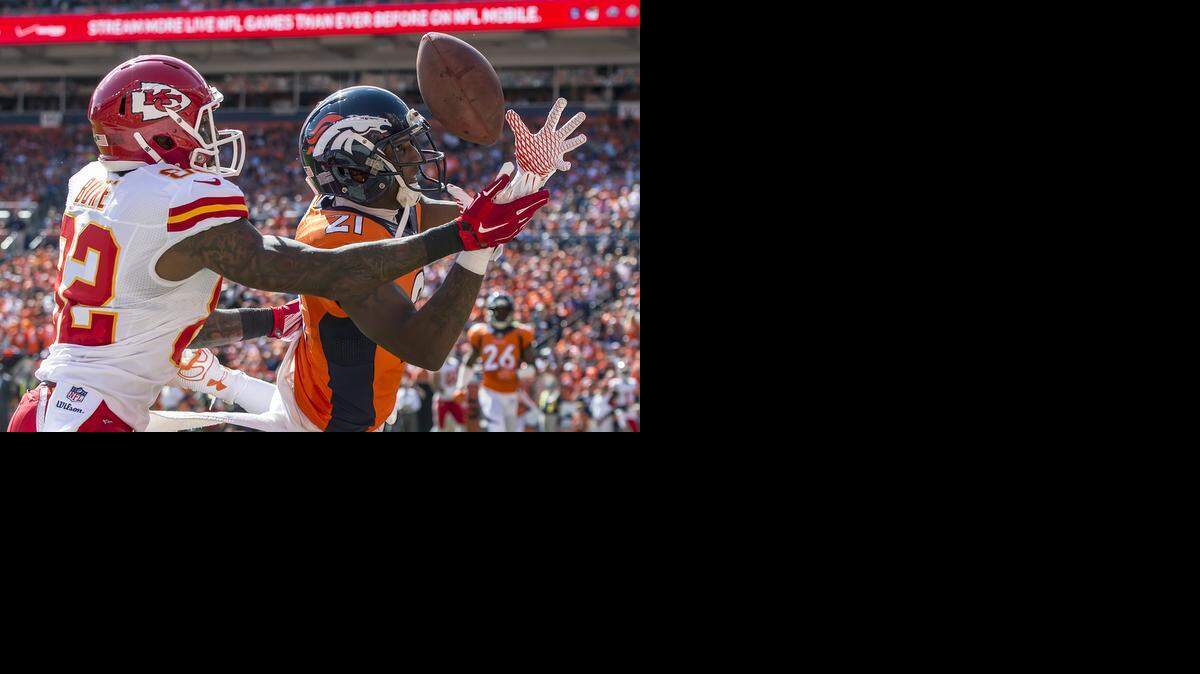 Denver Broncos cornerback Aqib Talib (21) bobbled an interception and dropped the football in the end zone behind intended receiver Kansas City Chiefs wide receiver Dwayne Bowe (82) in NFL action on September 14, 2014 at Sports Authority Field at Mile High in Denver, Co.