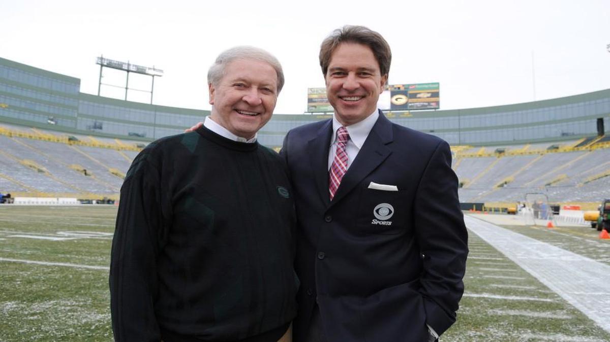 
Broadcaster Kevin Harlan, right, pictured with his father, Bob, at Lambeau Field in this file photo, has been in the business a long time. Like the rest of us, he’s never seen anything quite like what sports, the country and the world are going through right now.