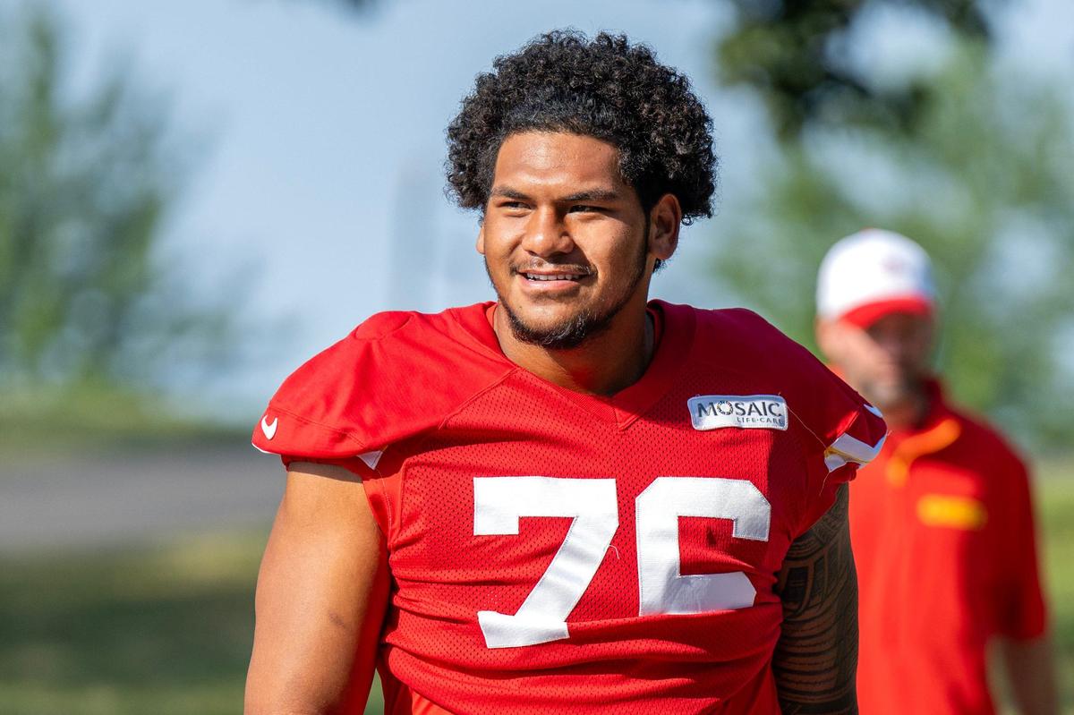 Kansas City Chiefs offensive tackle Kingsley Suamataia (76) smiles at fans as he walks down to the field for practice at Chiefs training camp on Monday, July 29, 2024, in St. Joseph.