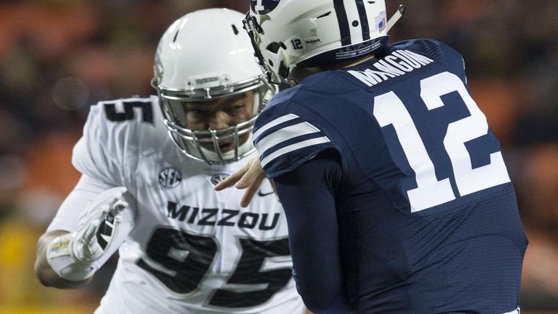 Missouri Tigers defensive lineman Rickey Hatley (95) applied pressure to Brigham Young quarterback Tanner Mangum (12) during a November 14, 2015 game at Arrowhead Stadium.