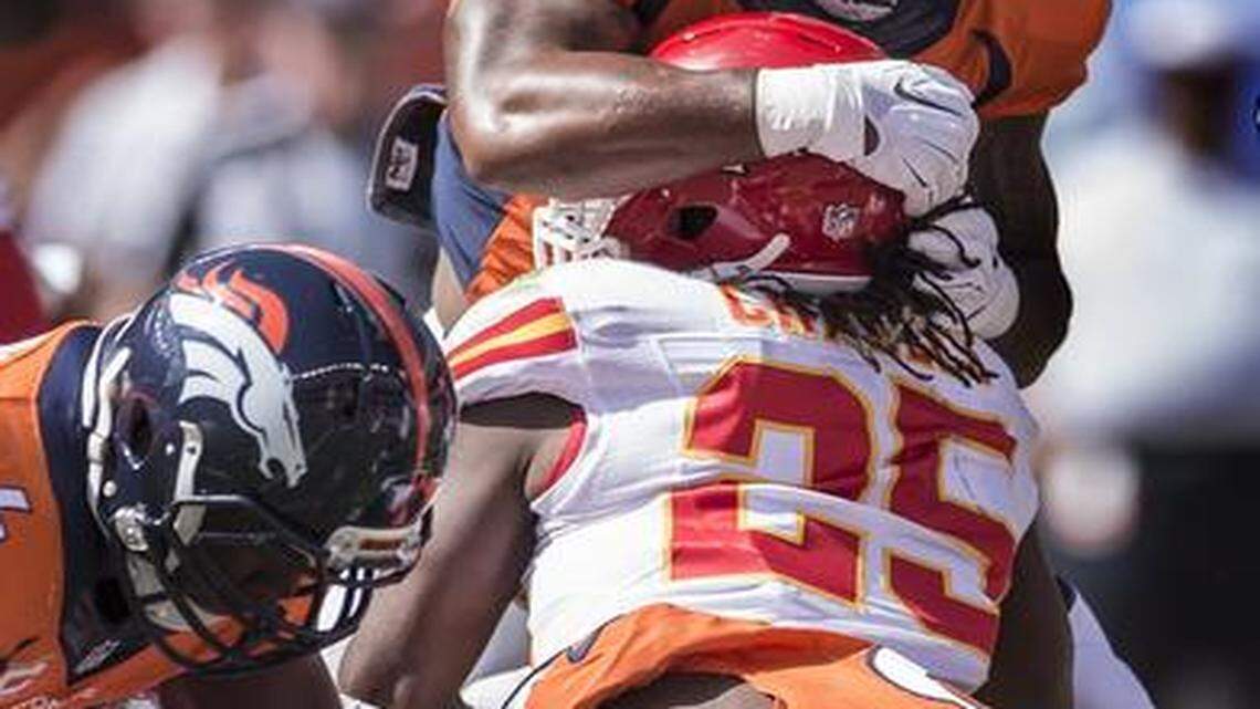 
Kansas City Chiefs running back Jamaal Charles (25) left the game after this first quarter play on a two-yard run against the Denver Broncos on Sunday at Sports Authority Field at Mile High in Denver, Co. Charles did not return and the Chiefs lost 24-17.
