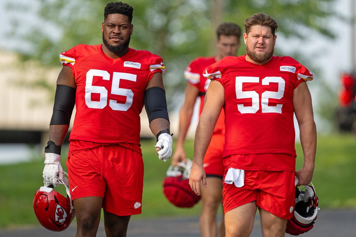 Chiefs guard Trey Smith (65) and center Creed Humphrey (52) walk to the field during training camp at Missouri Western State University on Wednesday, July 24, 2024, in St. Joseph.