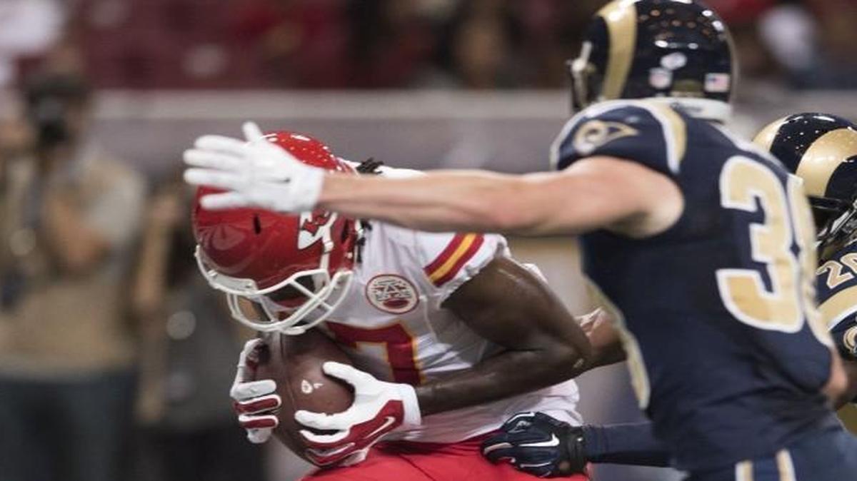 
Kansas City Chiefs wide receiver Chris Conley lowered his head and scored a touchdown as Rams defensive backs Cody Davis (center) and Lamarcus Joyner tried in vain to stop him.
