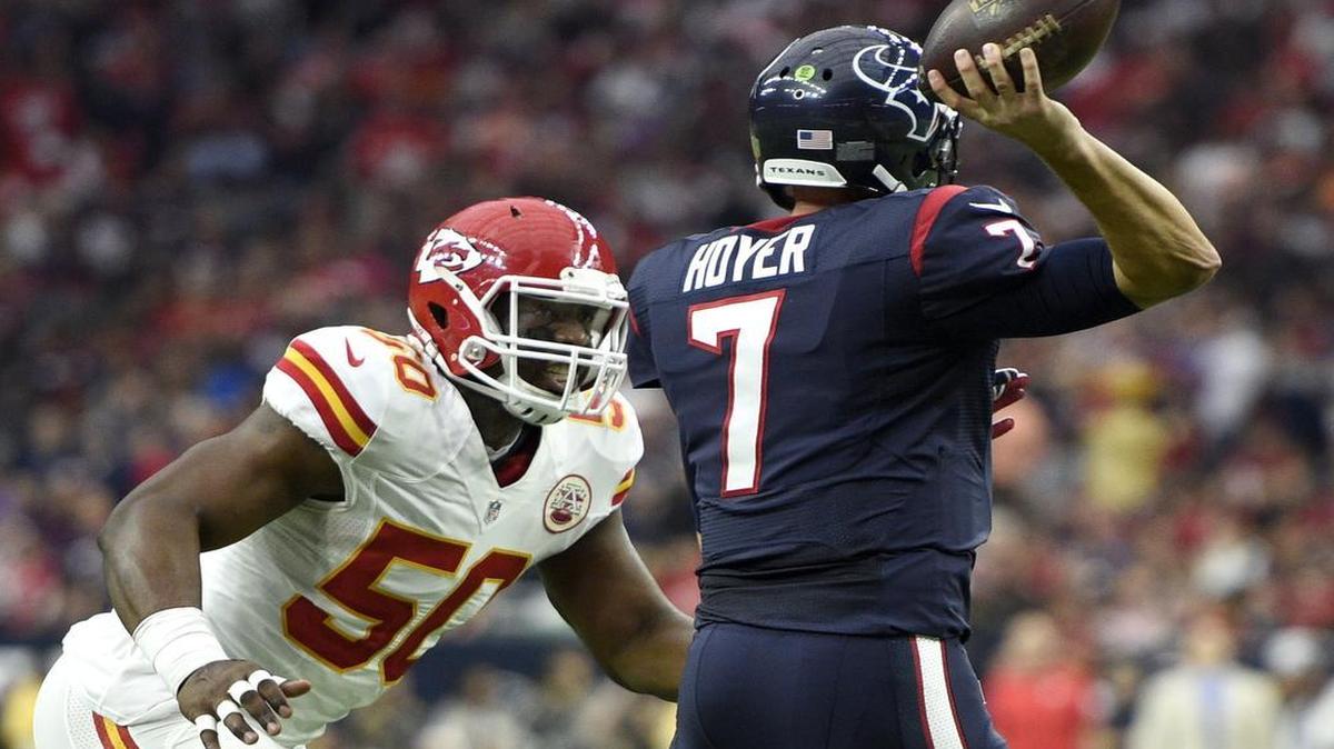 Chiefs outside linebacker Justin Houston closes in on Houston quarterback Brian Hoyer during the first quarter of their playoff game at NRG Stadium.
