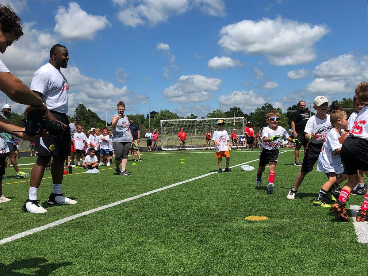 Kansas City Chiefs defensive lineman Chris Jones, left, watches an offensive play during his youth football camp on Wednesday, June 26, 2024 at Blue Valley Southwest High School in Overland Park, Kansas.