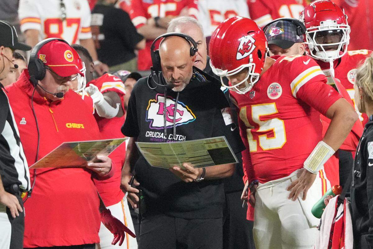 Kansas City Chiefs quarterback Patrick Mahomes (15) looks at plays with offensive coordinator Matt Nagy, center, and head coach Andy Reid against the New Orleans Saints during the first half on Oct. 7, 2024 at GEHA Field at Arrowhead Stadium in Kansas City.