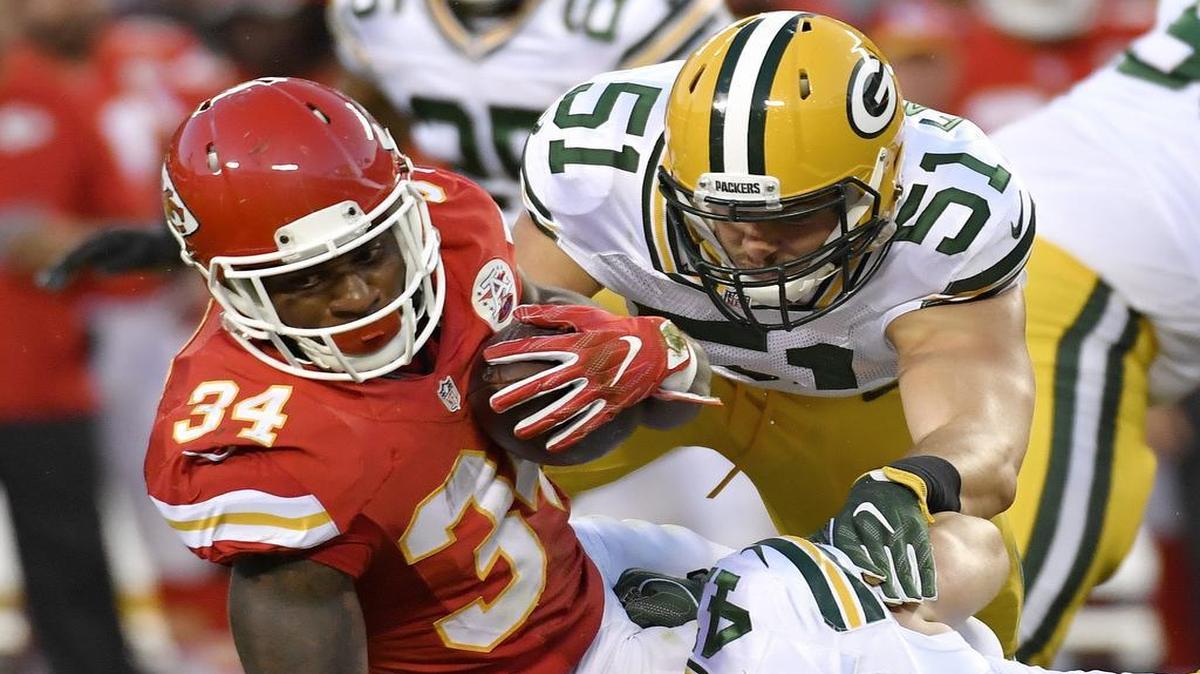 Kansas City Chiefs running back Knile Davis is brought down by Green Bay Packers outside linebacker Kyler Fackrell and inside linebacker Jake Ryan on September 1, 2016 at Arrowhead Stadium in Kansas City, Mo.