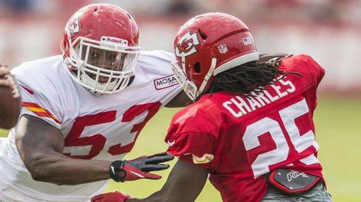 
Jamaal Charles (right) worked on his blocking against linebacker Joe Mays during training camp recently.


