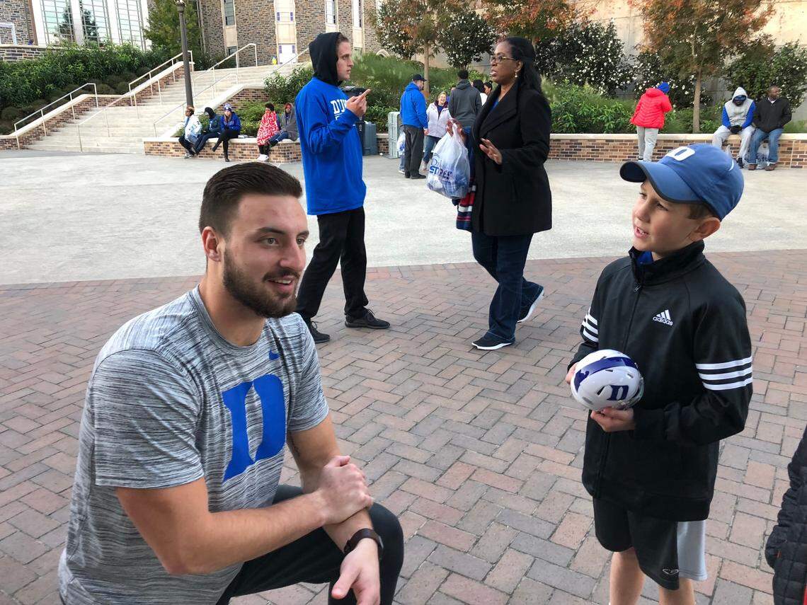 Kevin Jee, right, talks to current Kansas City Chiefs tight end and former Duke player Noah Gray after a Blue Devils game.