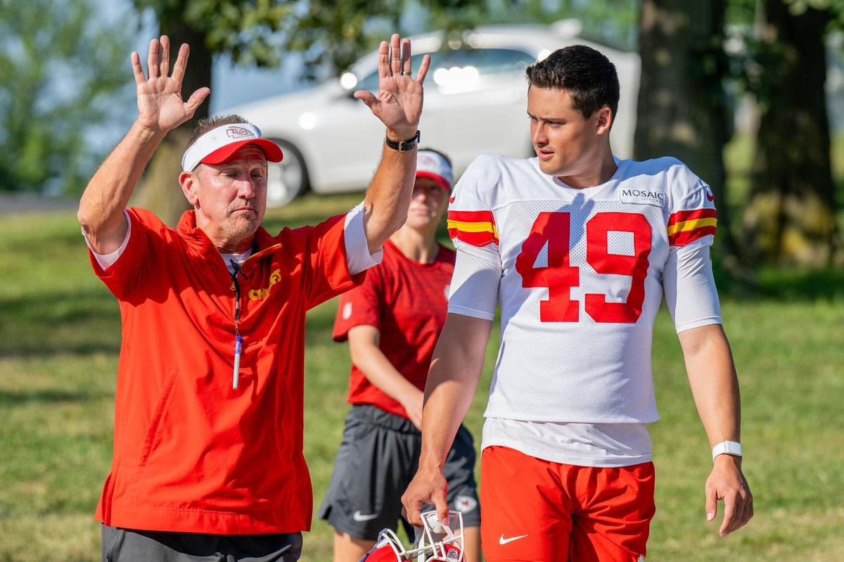 Kansas City Chiefs defensive coordinator Steve Spagnuolo and punter Matt Araiza (49) walk down to the field for practice at Chiefs training camp on Monday, July 29, 2024, in St. Joseph.