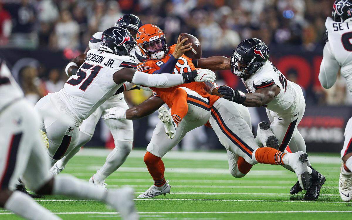 Houston Texans defensive end Will Anderson Jr. (51) and defensive end Danielle Hunter (55) attempt to sack Chicago Bears quarterback Caleb Williams (18) during the first quarter on Sept. 15, 2024 at NRG Stadium in Houston.