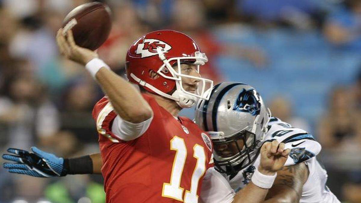 
Chiefs quarterback Alex Smith threw a pass under pressure from Carolina’s Star Lotulelei on Aug. 17.
