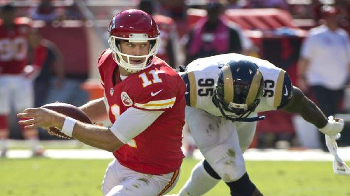 
The Kansas City Chiefs the St. Louis Rams on Sunday, Oct. 26, 2014, at Arrowhead Stadium in Kansas City. Kansas City Chiefs quarterback Alex Smith (11) eluded the grasp of St. Louis Rams defensive end William Hayes (95) in the second quarter.

