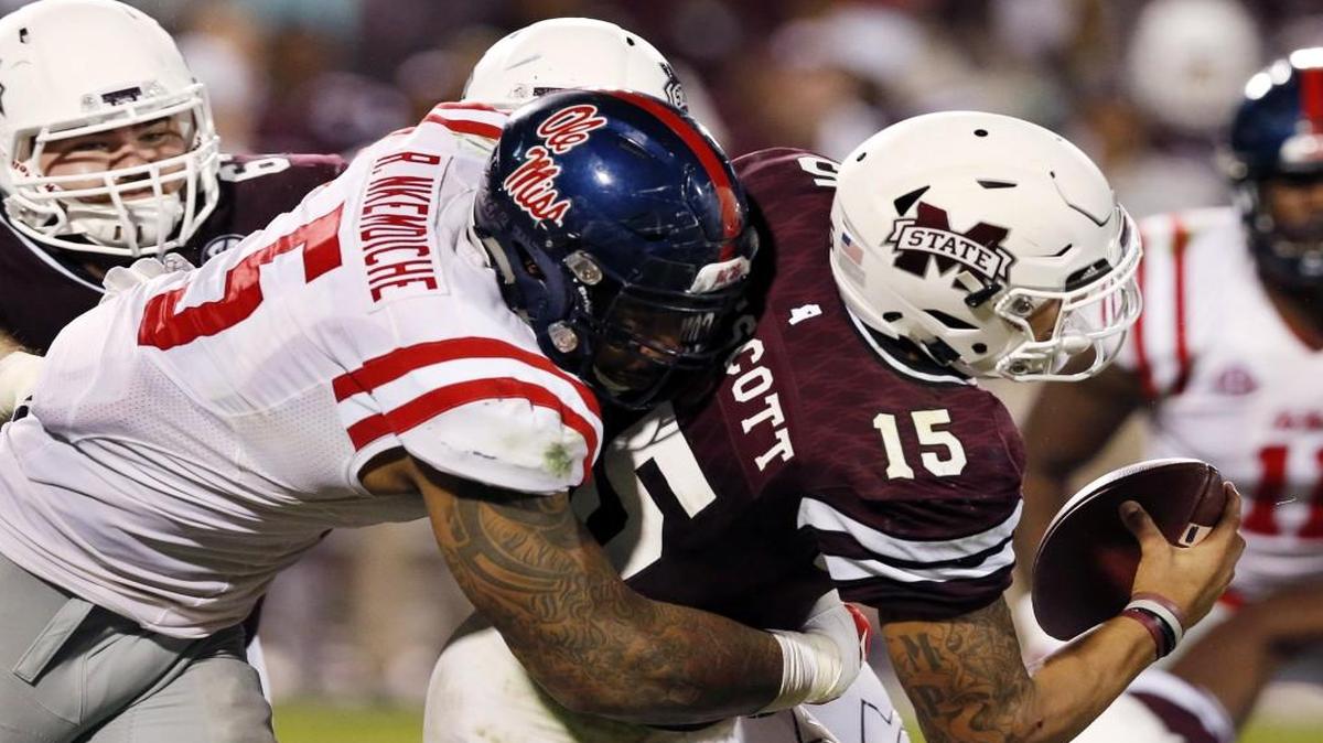 Mississippi State quarterback Dak Prescott was sacked by Mississippi defensive tackle Robert Nkemdiche during a game last year.