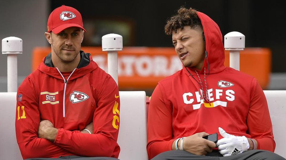 Kansas City Chiefs starting quarterback Alex Smith (left) and Patrick Mahomes sit on a sideline bench prior to a game against the New York Jets on Sunday, Dec. 3, 2017, at MetLife Stadium in East Rutherford, N.J.