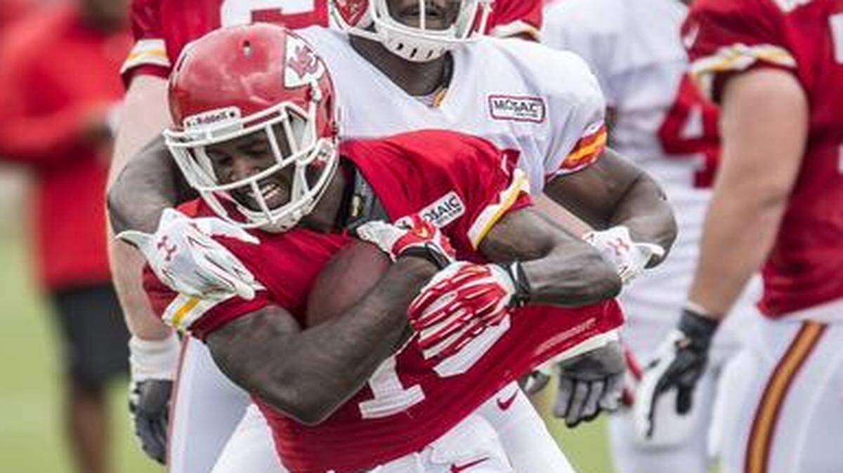 
Kansas City Chiefs running back De’Anthony Thomas (1) was wrapped up by Kansas City Chiefs linebacker Dee Ford (55) on Saturday morning during Kansas City Chiefs summer training camp practice at Missouri Western State University in St. Joseph, Mo. Thomas has been able to avoid big hits so far in camp.
