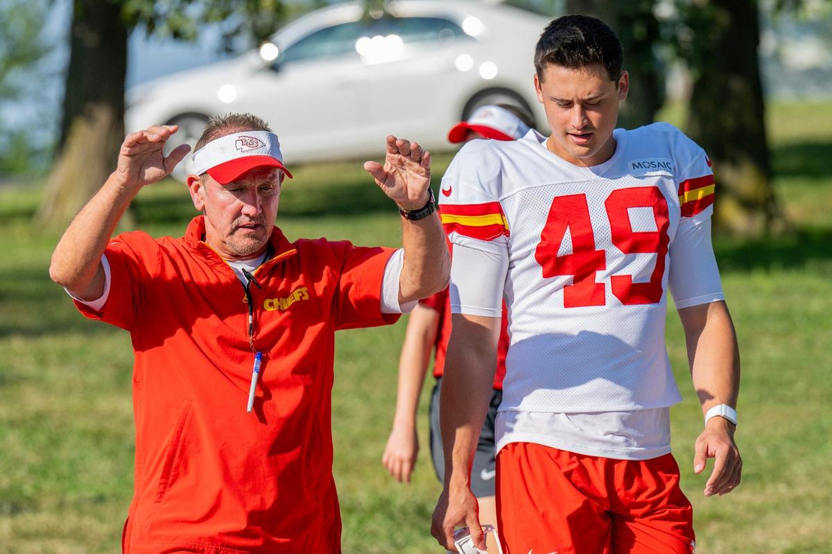 Kansas City Chiefs defensive coordinator Steve Spagnuolo and punter Matt Araiza (49) walk down to the field for practice at Chiefs training camp on Monday, July 29, 2024, in St. Joseph.