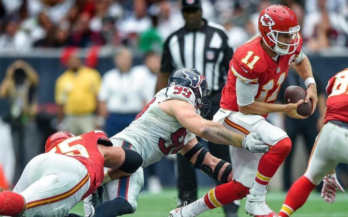 Kansas City Chiefs quarterback Alex Smith eluded the tackle attempt of Houston Texans defensive end J.J. Watt during a game on Sept. 13, 2015 at NRG Stadium in Houston. The Chiefs won 27-20.