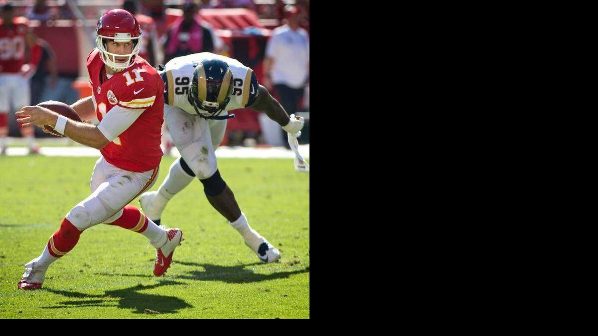 
The Kansas City Chiefs the St. Louis Rams on Sunday, Oct. 26, 2014, at Arrowhead Stadium in Kansas City. Kansas City Chiefs quarterback Alex Smith (11) eluded the grasp of St. Louis Rams defensive end William Hayes (95) in the second quarter.
