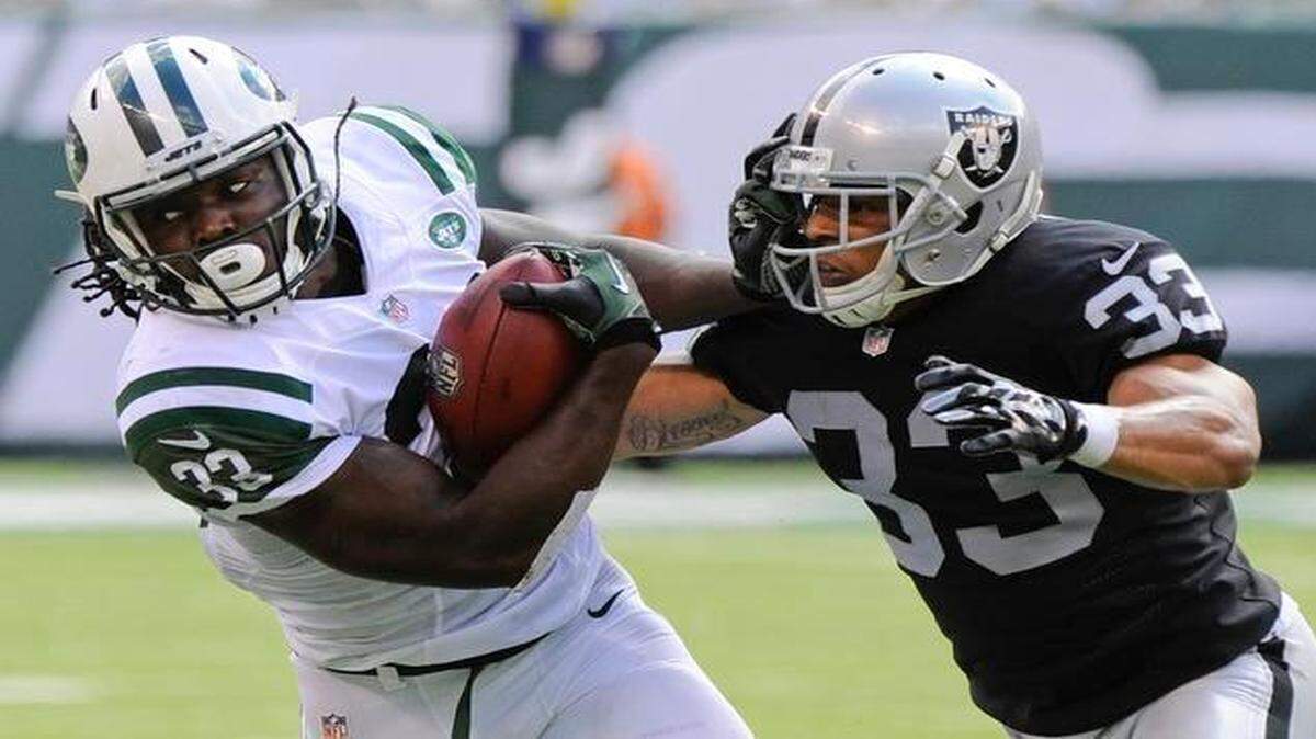 
Oakland Raiders safety Tyvon Branch tackled New York Jets running back Chris Ivory on Sept. 7, 2014, in East Rutherford, N.J. 
