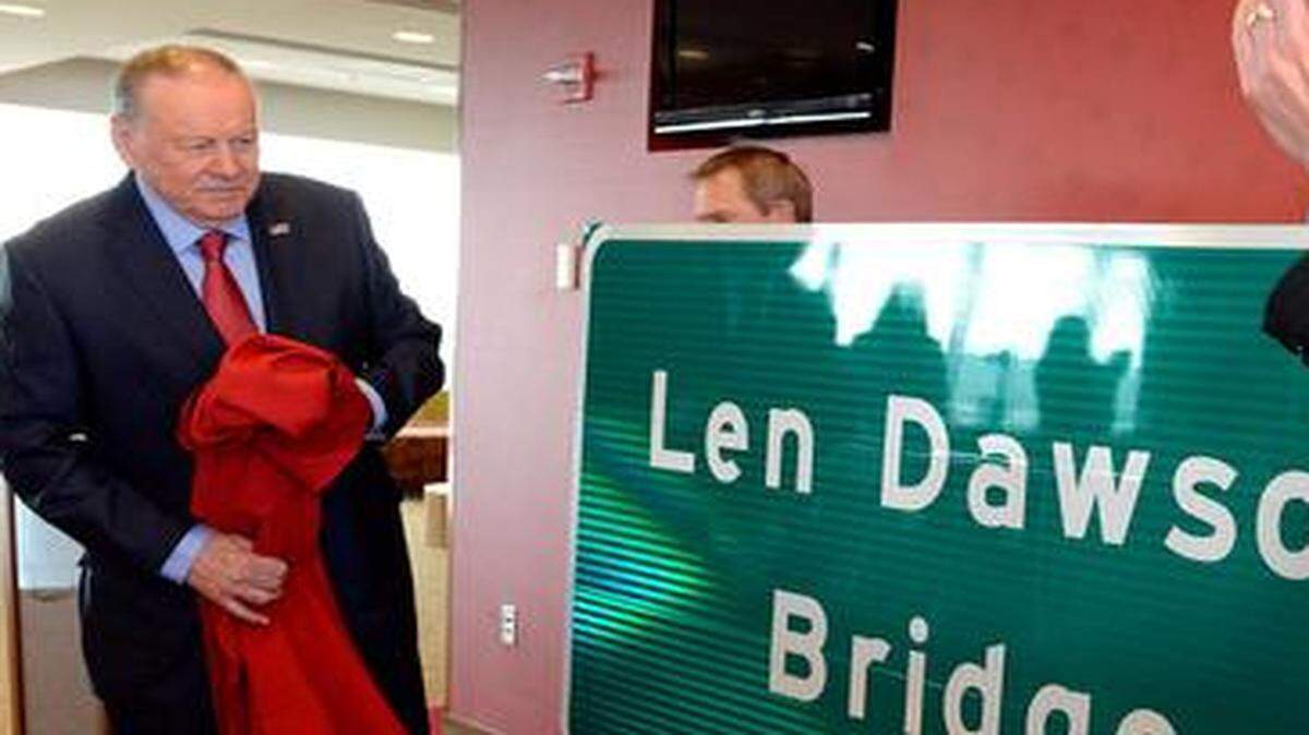 
Halll of Fame quarterback Len Dawson, left, gets the first look of a new highway sign in his honor while dignitaries including Stephen Miller, right, Chairman of the Missouri Highways and Transportation Commission, clap Friday at Arrowhead Stadium. East Stadium Drive over Interstate 435 has been designated the "Len Dawson Bridge."
