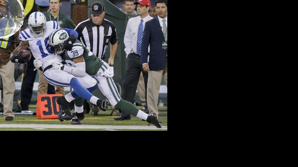 
New York Jets free safety Antonio Allen (39) tackles Indianapolis Colts wide receiver Da'Rick Rogers (16) in the second quarter of a preseason NFL football game, Thursday, Aug. 7, 2014, in East Rutherford, N.J. 
