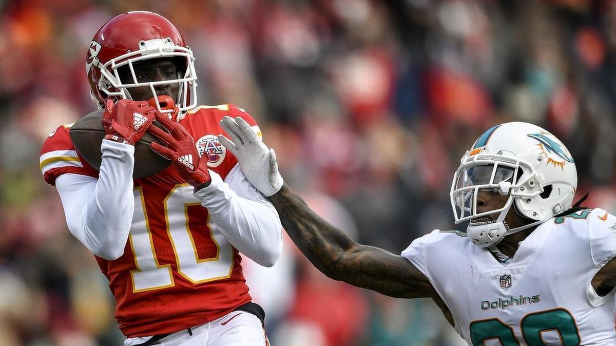 Kansas City Chiefs wide receiver Tyreek Hill, left, hauls in a catch during a game against the Miami Dolphins.